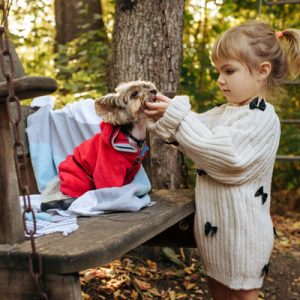 a little girl with her pet dog