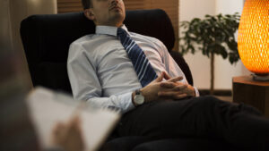 A man is in a hypnotic state during a QHHT session.